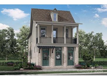 Charming two-story home with a balcony, complemented by lush landscaping and a welcoming front yard at 641 Hops Aly, Fort Mill, SC 29715