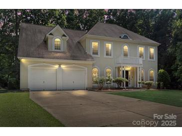 Charming traditional home with a two-car garage, manicured lawn, and covered front entrance at 7151 Plough Dr, Mint Hill, NC 28227