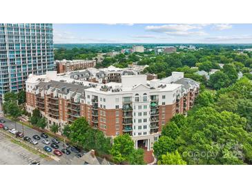 Brick condo building featuring manicured landscaping, private balconies, and convenient parking at 300 W 5Th St # 617, Charlotte, NC 28202