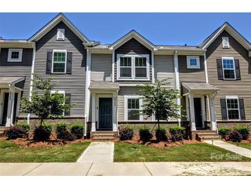 Charming townhome featuring a well-maintained front yard with lush landscaping and a welcoming entrance at 8388 Waxhaw Hwy, Waxhaw, NC 28173