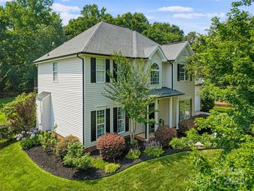 Charming two-story home featuring well-maintained landscaping and a classic design at 129 Nims Spring Dr, Fort Mill, SC 29715