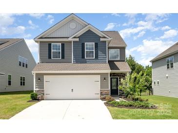 Two-story home with a two-car garage and landscaping at 12912 Canterbury Castle Dr, Charlotte, NC 28273