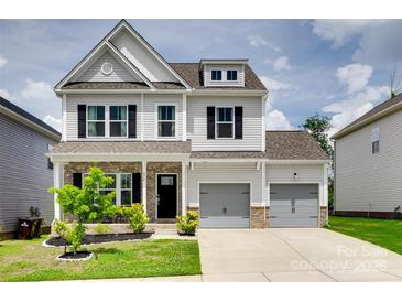 Beautiful two-story home featuring gray siding, brick accents, and a well-manicured front yard at 972 Von Buren Blvd # 242, Rock Hill, SC 29730