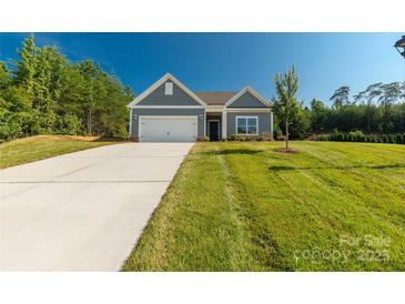Charming single-story home with a well-manicured lawn and attached two-car garage at 10180 Lakeshore Dr, Lancaster, SC 29720