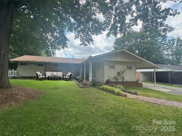 Charming single-story home featuring a brick facade, cozy outdoor seating, and a well-manicured lawn at 1107 Crestfield Dr, Lancaster, SC 29720