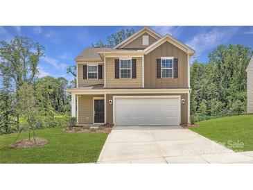 Inviting two-story home with attached two-car garage, manicured lawn, and a classic facade at 136 Dorian Pl, Troutman, NC 28166