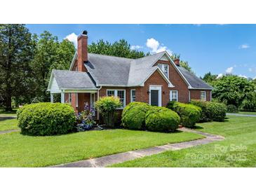 Charming brick home with lush landscaping, a neatly manicured lawn, and inviting curb appeal at 1520 21St Ne Ave, Hickory, NC 28601