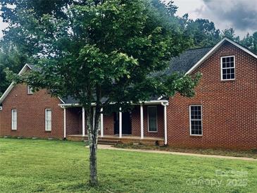 Charming single Gathering home featuring a brick facade and covered porch with manicured lawn at 2765 Dogwood Cir, Rock Hill, SC 29732
