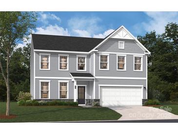 Charming two-story home featuring a classic design, a two-car garage, and well-manicured lawn at 4125 Vista Pine Dr, Charlotte, NC 28215