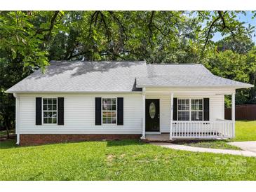 Charming single-story home with black shutters, a well-manicured lawn, and a quaint front porch at 429 Merry Go Dr, York, SC 29745