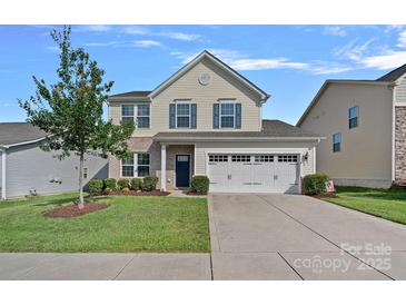 Charming two-story home with blue shutters, attached garage and beautiful lawn at 1527 Scarbrough Sw Cir, Concord, NC 28025