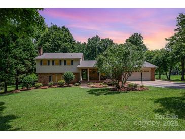 Charming two-story home with brick accents, mature landscaping, and a two-car garage in a beautiful, serene setting at 2109 Quail Nw Dr, Concord, NC 28027