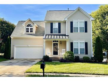 Charming two-story home with a well-manicured lawn, two-car garage, and inviting front porch with rocking chairs at 3301 Old Knobbley Oak Dr, Gastonia, NC 28056