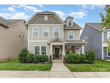 Charming two-story home with landscaped yard and covered front porch at 3332 Katherine Taylor Ct, Monroe, NC 28110