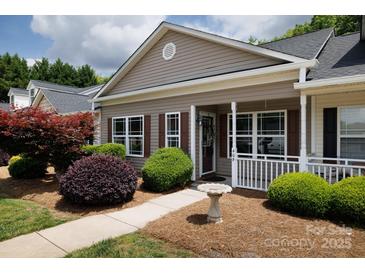 Inviting home exterior featuring manicured landscaping and a charming covered porch at 409 Guiness Pl, Rock Hill, SC 29730