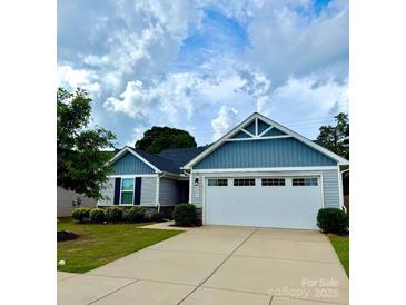 Charming single-story home featuring a two-car garage and beautiful blue and gray siding at 4227 Mackinnon Dr, Charlotte, NC 28214