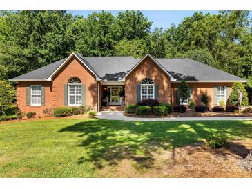 Charming one-story brick home featuring lush landscaping and a well-manicured lawn, perfect for curb appeal at 600 Queens Rd, Cherryville, NC 28021