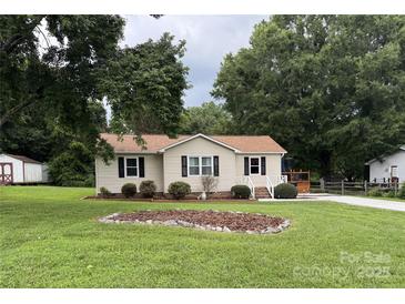 Charming single-story home with manicured lawn, landscaping, and a quaint front porch at 618 Springfield Nw Dr, Concord, NC 28027