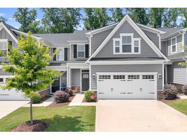 Charming gray two-story home with a well-manicured lawn, two-car garage, and inviting landscaping at 6365 Ashton Park Dr, Denver, NC 28037