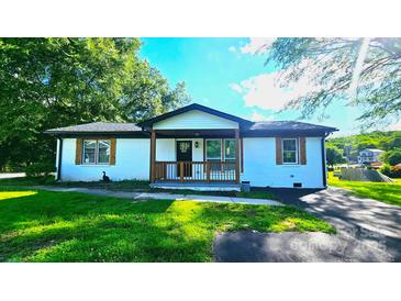 Charming, freshly painted home with well-maintained lawn and inviting front porch at 703 Central Nw Dr, Concord, NC 28027