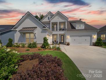 Stunning two-story home boasts a well-manicured lawn, elegant trim, and a three-car garage at 7150 Irongate Dr, Indian Land, SC 29707
