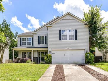 Charming two-story home featuring a well-manicured lawn and a two-car garage at 14307 Hartwell Farm Dr, Charlotte, NC 28278