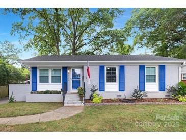 Charming brick home with blue shutters, manicured lawn, and inviting entrance at 1744 Emerywood Dr, Charlotte, NC 28210