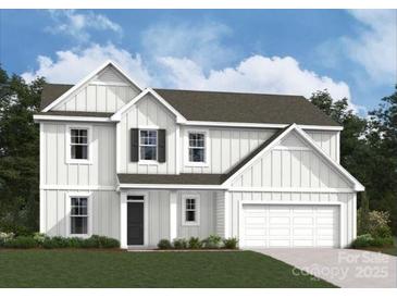 Charming two-story home featuring white siding, black door, and a two-car garage at 294 Winford Rd, Troutman, NC 28116