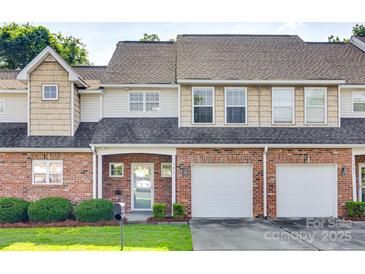 Charming townhome with brick facade, attached garages, manicured lawn, and inviting curb appeal at 349 Valley Brook Se Ln, Concord, NC 28025