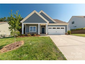 Charming home features a welcoming front porch and a well-manicured lawn, perfect for curb appeal at 5244 Admirals Lndg, Lancaster, SC 29720