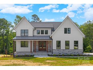New construction two-story home with white siding, gray accents, black-trimmed windows, and covered porch at 537 Riddle Mill Rd, Clover, SC 29710