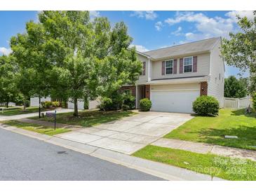 Charming two-story home with a well-manicured lawn and a spacious driveway at 9416 Cotton Gum Rd, Charlotte, NC 28227