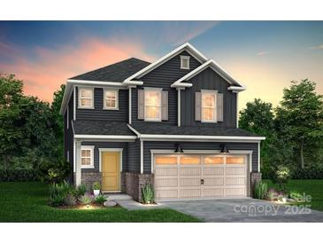 Charming two-story home with a two-car garage, stylish shutters, and manicured lawn at 14019 Penbury Ln # 372, Charlotte, NC 28278