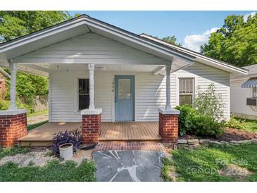 Charming home with a covered front porch featuring brick pillars and a light blue door at 1626 W Park Ave, Albemarle, NC 28001