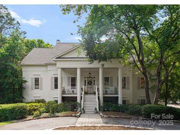 A beautiful white house with a large front porch and columns at 2324 Kingsmill Ter, Charlotte, NC 28270