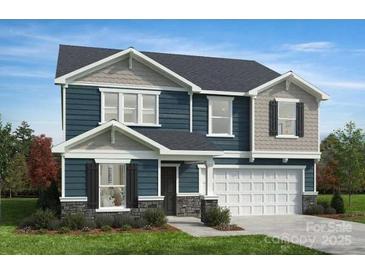 Charming two-story home featuring a mix of siding, stone accents, and a spacious two-car garage at 3228 Maya Ln # 40, Midland, NC 28107