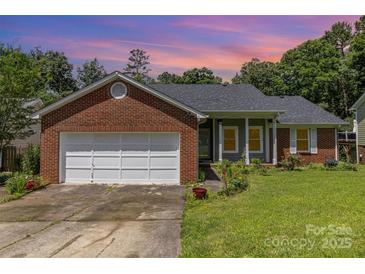 Charming brick home with a well-maintained lawn and attached garage at 9520 Marshbrooke Rd, Matthews, NC 28105