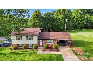 Charming split-level home with a well-manicured lawn, brick accents, and a convenient carport for parking at 103 Little Forest Ln, Statesville, NC 28625