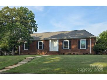 Charming brick home featuring a well-manicured lawn and classic architectural details at 1280 Queensgate St, Gastonia, NC 28054