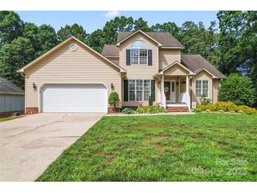 Charming two-story home featuring a manicured front yard and a two-car garage at 1701 Whitney Ln, Salisbury, NC 28146