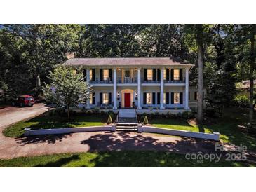 Stately two-story home featuring a red front door and large columns at 327 Saint Andrews Rd, Statesville, NC 28625