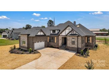 Beautiful two-story home featuring brick and stone accents, with a two-car garage and manicured front yard at 106 Kelly Marie Ct, Kings Mountain, NC 28086
