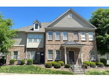 Attractive brick townhome with manicured landscaping and a welcoming front entrance with a black door at 12421 Fiorentina St, Charlotte, NC 28277