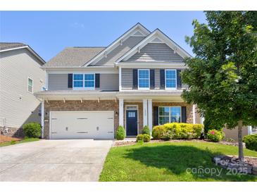 Charming two-story home with stone accents, a two-car garage, and manicured landscaping in a desirable neighborhood at 1325 Grantwood Nw Ave, Concord, NC 28027