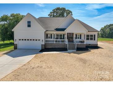Charming new construction home featuring a welcoming front porch and attached two car garage at 133 Harbourtown Dr, Kings Mountain, NC 28086