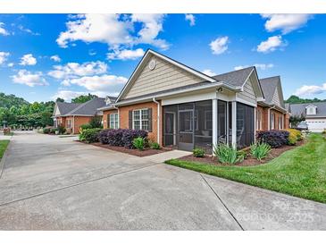 Charming brick home features a screened porch, well-maintained landscaping, and a concrete driveway at 2369 Stardust Ct, Denver, NC 28037