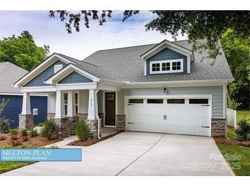 Charming home featuring stone accents, a two-car garage, and a welcoming front porch at 608 Banter Ln # 31, Cramerton, NC 28032