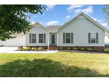 Charming single story home featuring manicured lawn, landscaped garden beds, and stylish shutters at 614 W Peeler St, Salisbury, NC 28146