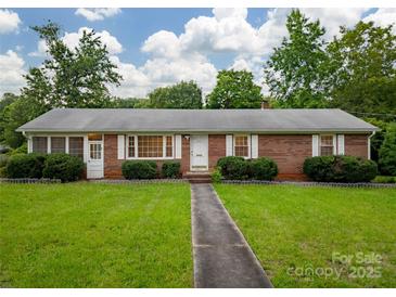 Charming brick home featuring a well-manicured lawn and walkway leading to the front door, perfect for curb appeal at 1132 Arbor Dr, Salisbury, NC 28144