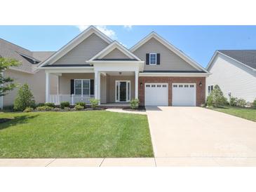 Charming home with a welcoming front porch, brick accents, and a well-manicured lawn at 14019 Cameryn Elise Dr, Cornelius, NC 28031
